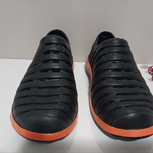 child's Coppertone slip-on water shoes, size in 13-1, orange and black